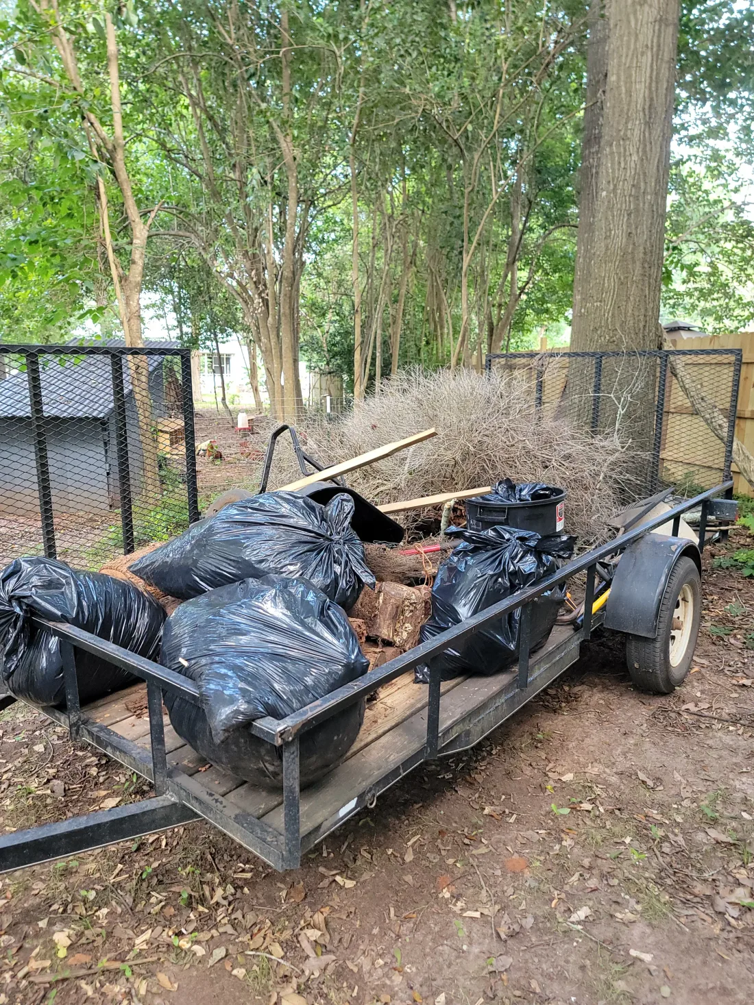 Junk Be Gone hauling trailer on a real service job